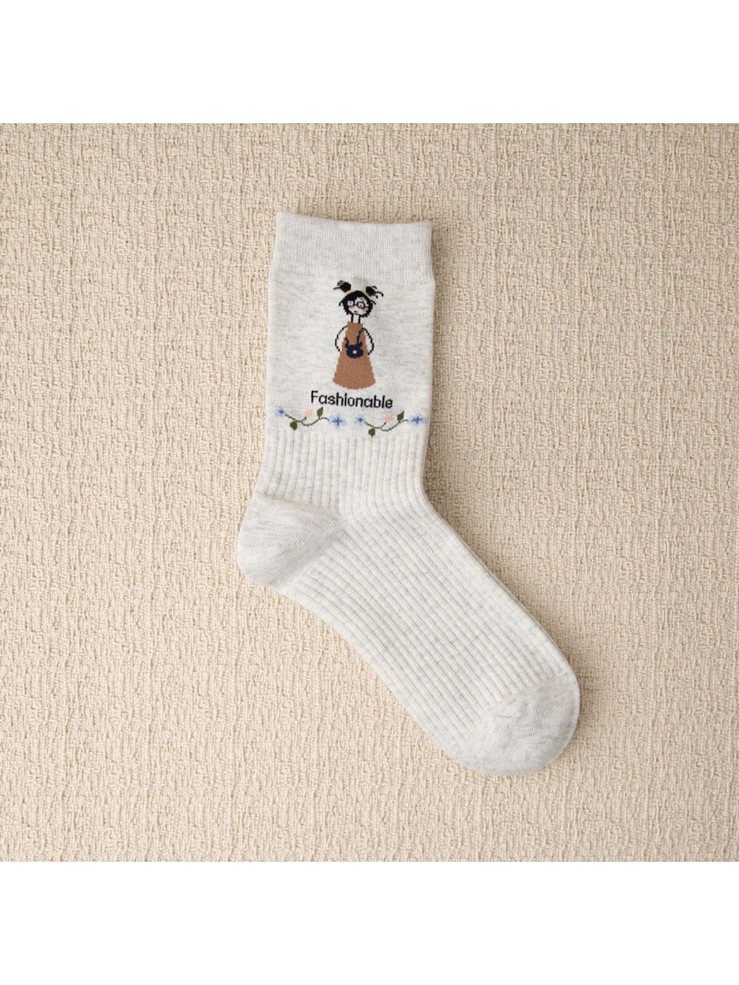 Light gray crew sock with cartoon girl and floral vine motif