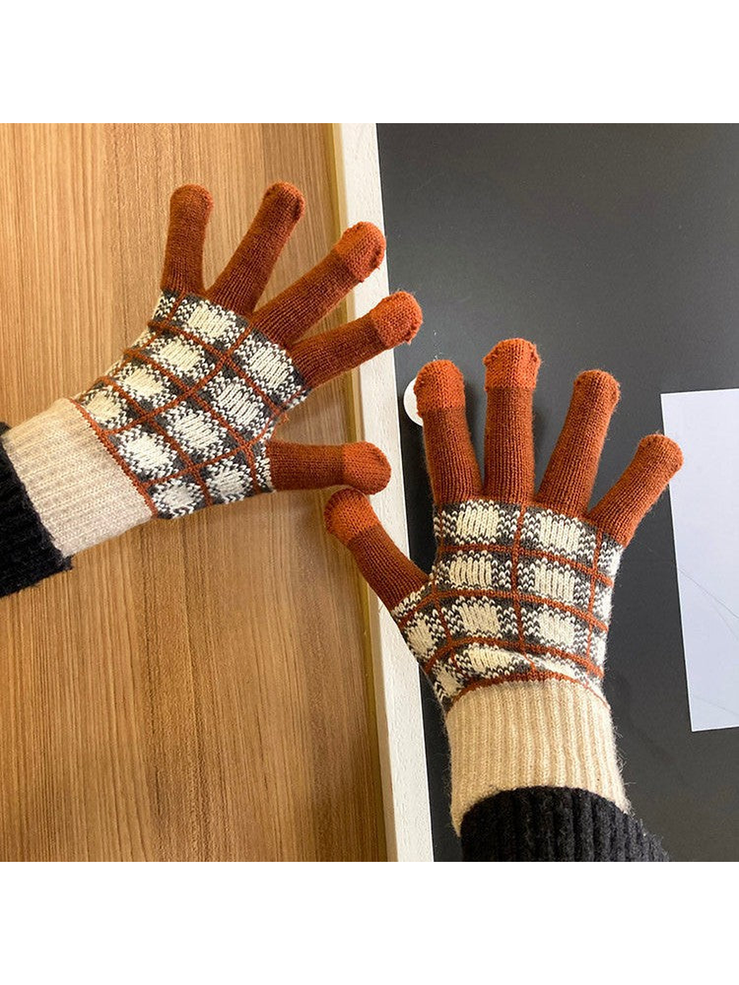 Brown and cream checked gloves worn with palms facing forward