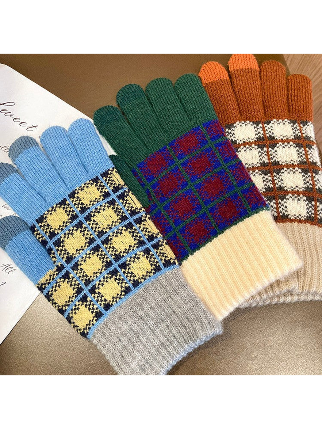 Blue, green and brown checked gloves displayed together