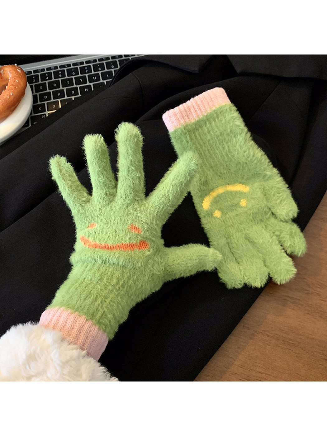 Green fuzzy smiley-face gloves showing palm and back views