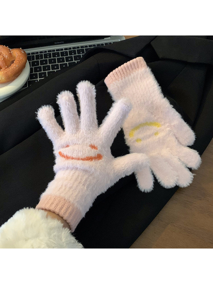 Light pink fuzzy smiley-face gloves showing palm and back views