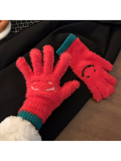 Red fuzzy smiley-face gloves showing palm and back views