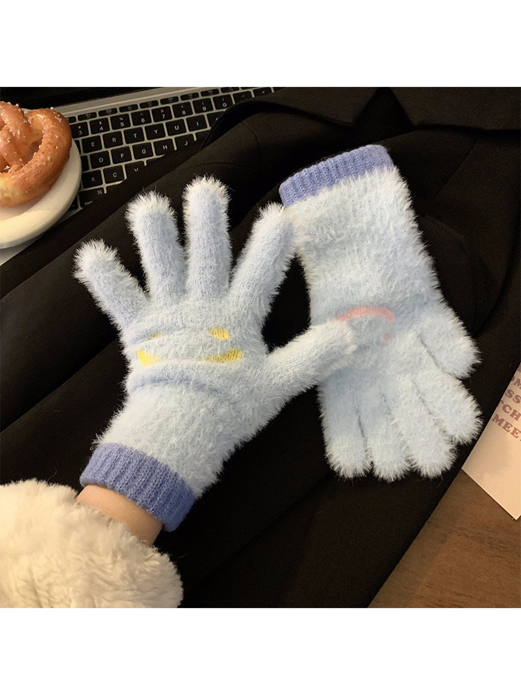 Sky blue fuzzy smiley-face gloves showing palm and back views