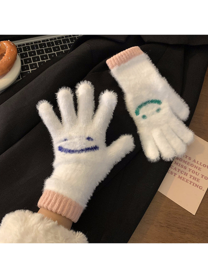 White fuzzy smiley-face gloves showing palm and back views