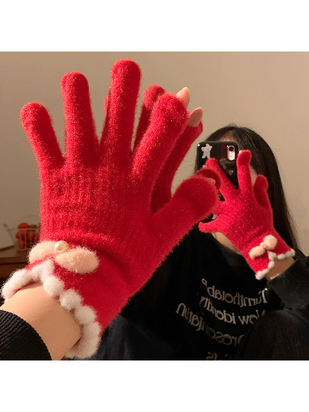 Red fuzzy gloves with open fingertips and bow-accent cuffs