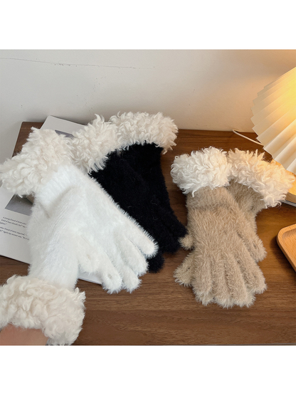 White, black and khaki fuzzy gloves with curly white cuffs displayed together