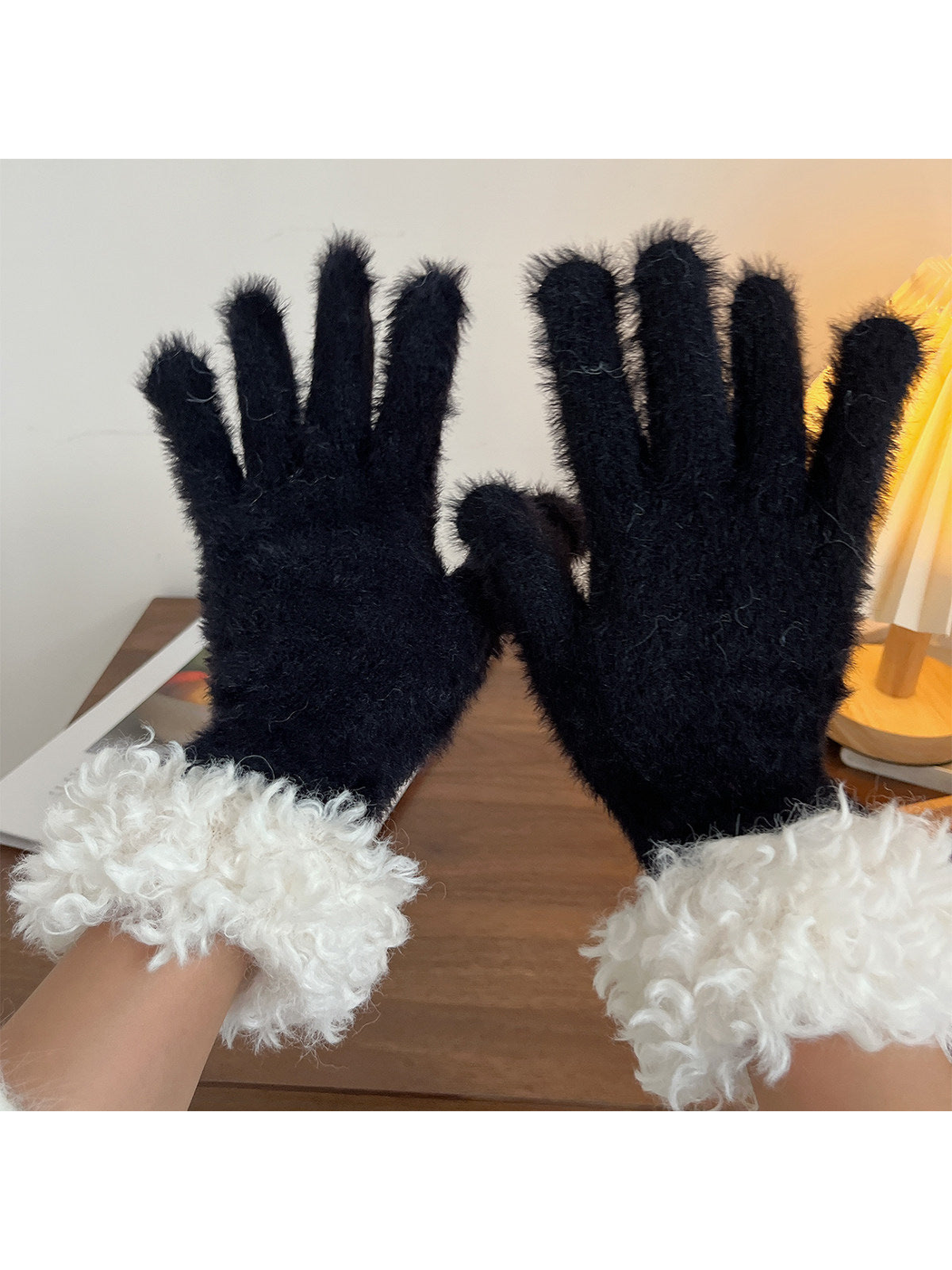 Black fuzzy gloves with curly white cuffs, pair view