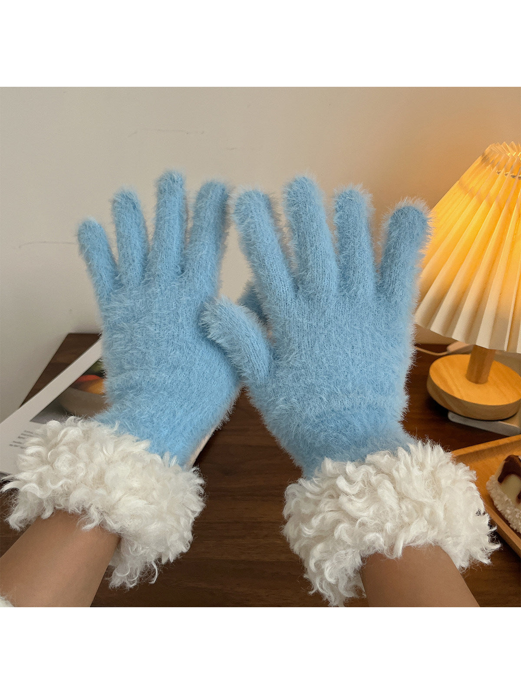 Sky blue fuzzy gloves with curly white cuffs, pair view