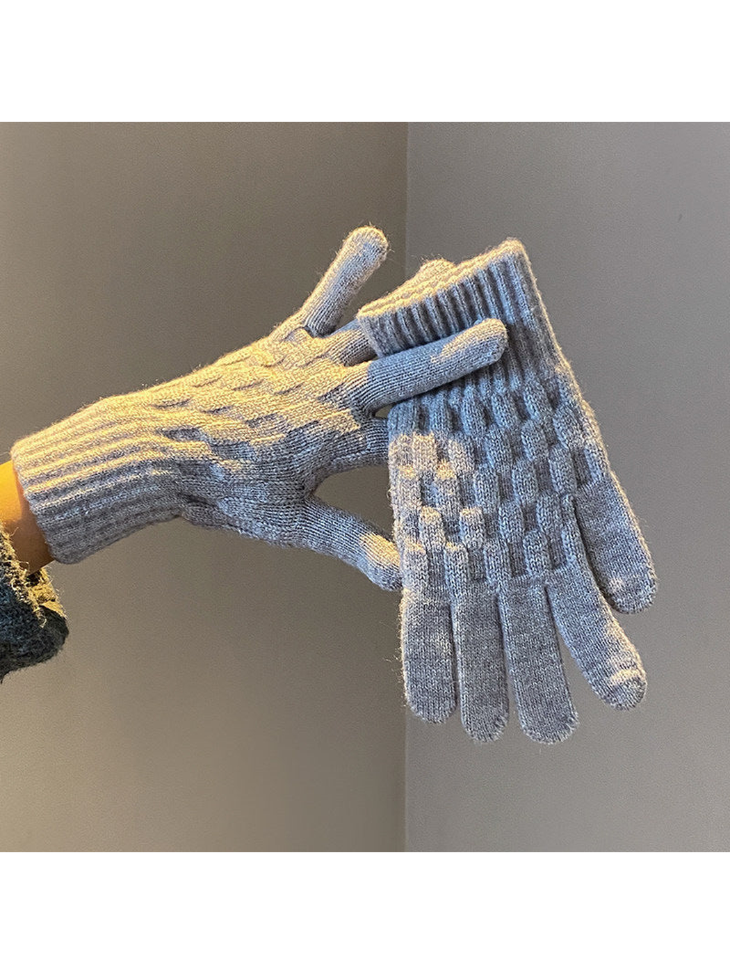 Gray cable-knit gloves with ribbed cuffs, worn and held view