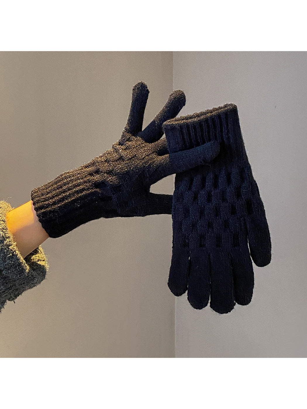 Black cable-knit gloves with ribbed cuffs, worn and held view