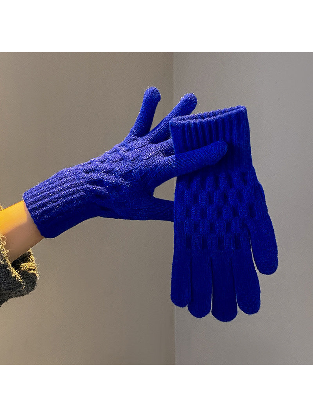 Blue cable-knit gloves with ribbed cuffs, worn and held view