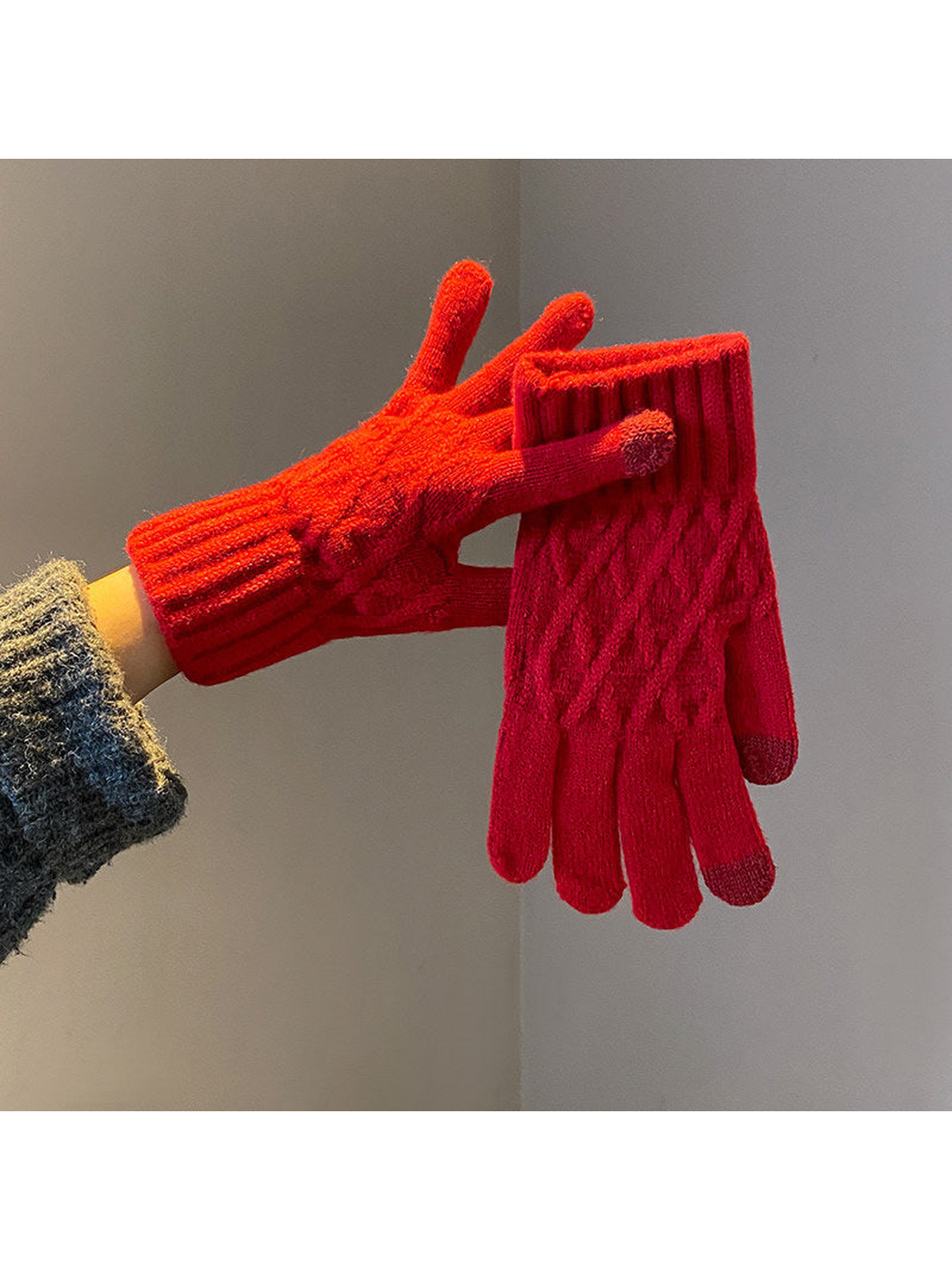Red cable-knit gloves with ribbed cuffs, worn and held view