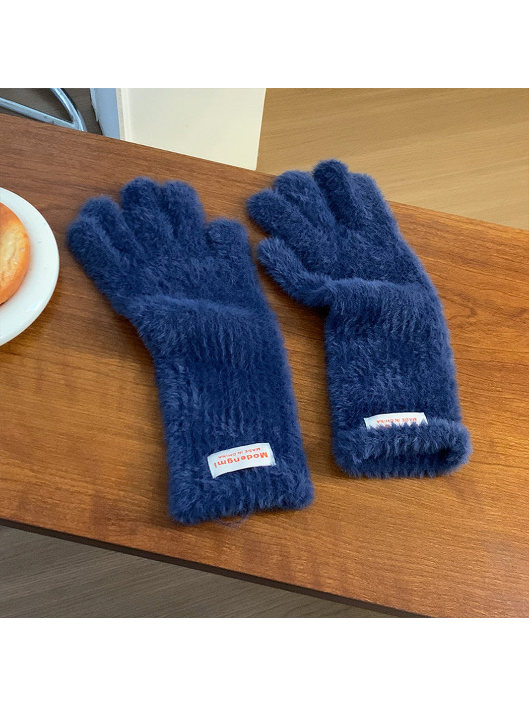 Navy fuzzy gloves with extended cuffs, angled view