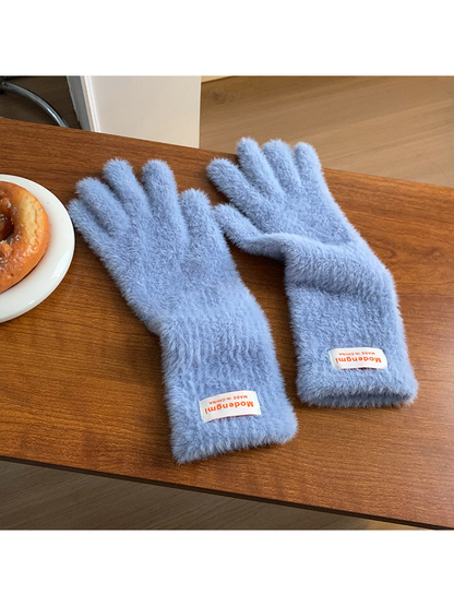 Light blue fuzzy gloves with extended cuffs, angled view