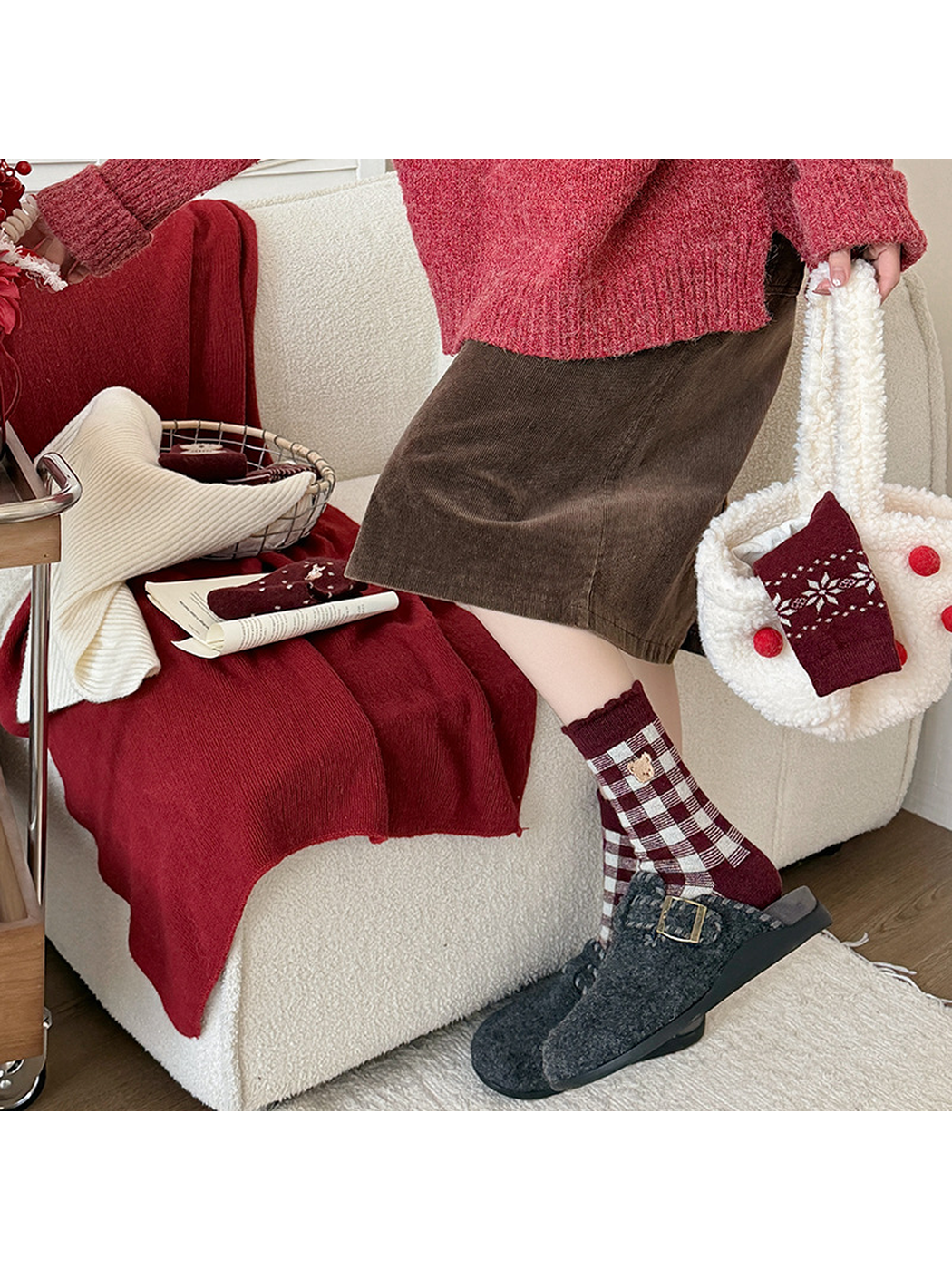 Burgundy checkered crew socks styled with gray buckle slippers