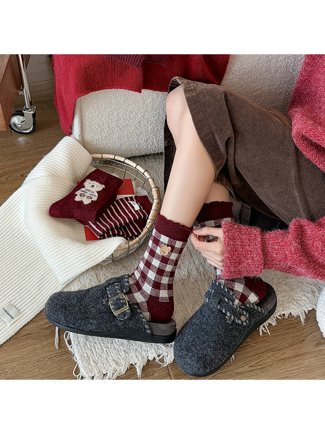 Burgundy checkered crew socks in a seated indoor styling scene