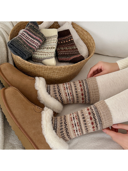 Geometric crew socks in four colorways styled with slippers and a woven basket