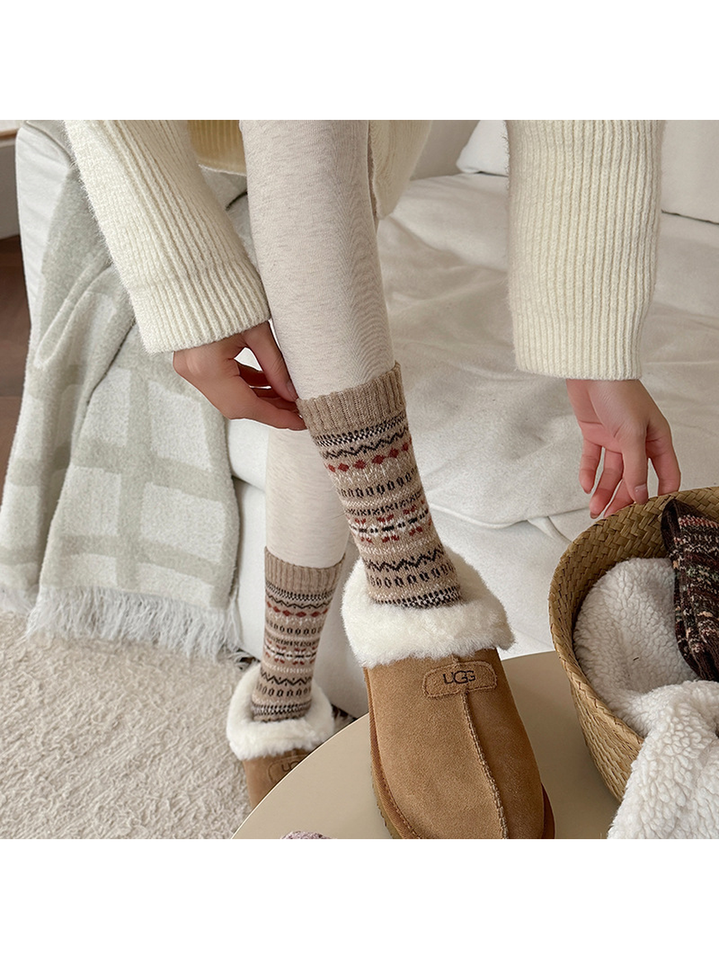 Beige geometric crew socks worn with shearling-trimmed slippers