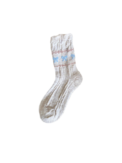 Beige ribbed crew sock with blue bow motifs and pink zigzag bands