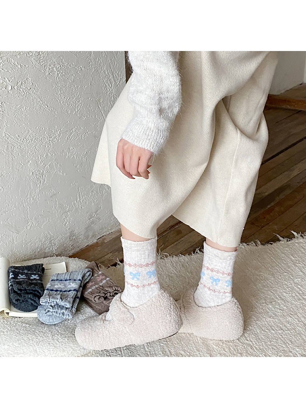 Beige bow-pattern crew socks worn with plush slip-on shoes
