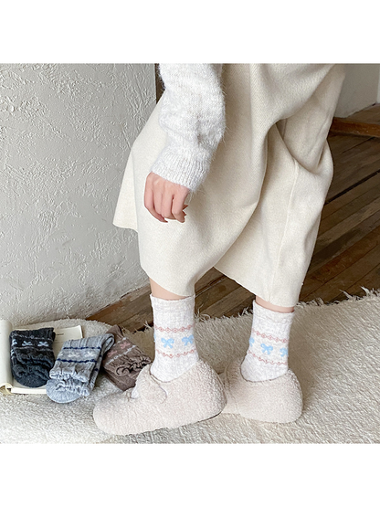 Beige bow-pattern crew socks worn with plush slip-on shoes