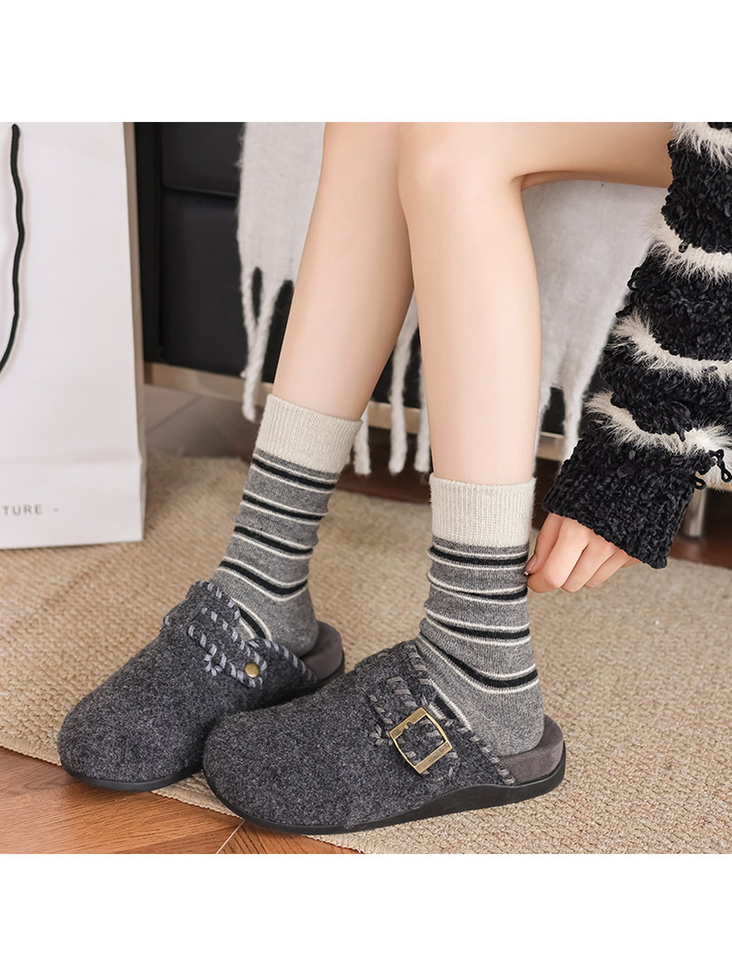 Gray striped crew socks worn with gray slippers