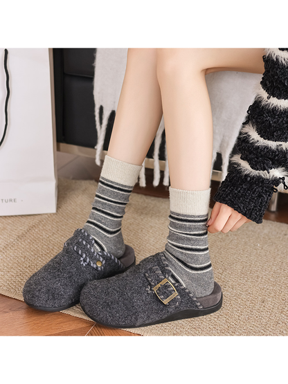 Gray striped crew socks worn with gray slippers