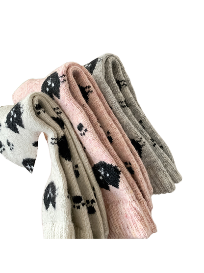 Close-up of fuzzy cat-pattern crew socks in multiple colors