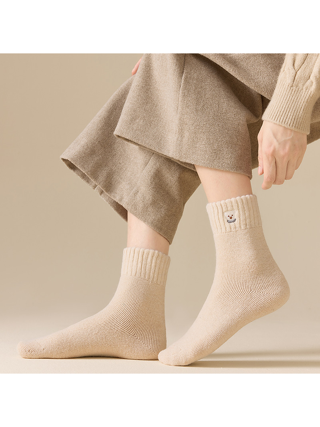 Beige ribbed crew socks worn in a standing side view