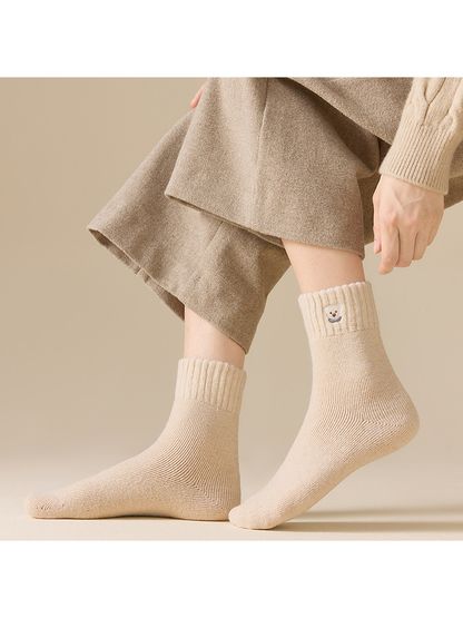 Beige ribbed crew socks worn in a standing side view