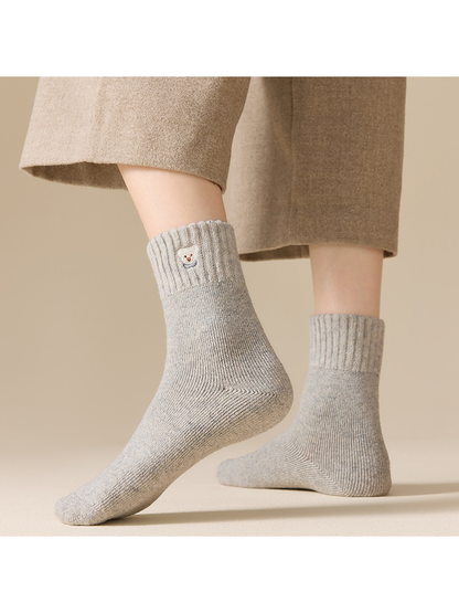 Light gray ribbed crew socks worn in a standing front-and-side view