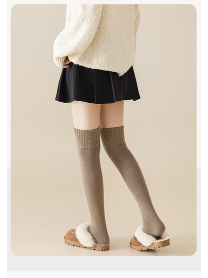 Light coffee over-the-knee socks shown from the back with fleece-lined slippers