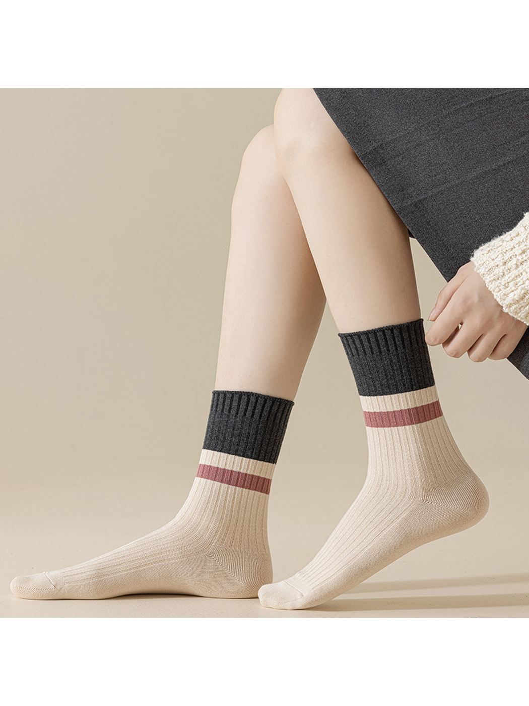 Ivory crew socks with dark gray cuffs worn without shoes