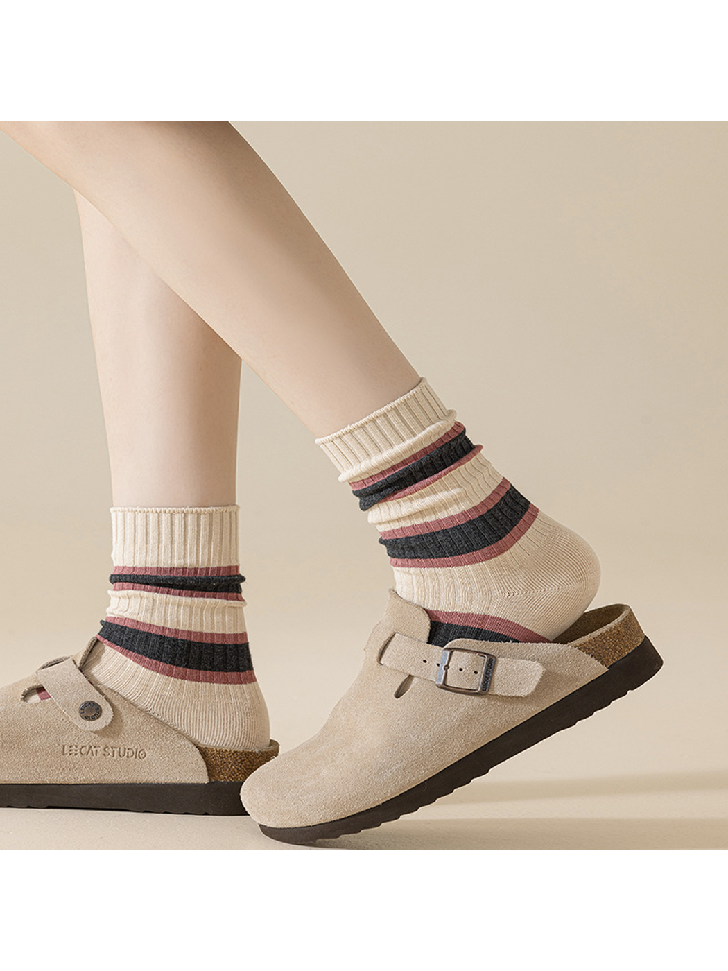 Ivory mixed-stripe crew socks styled scrunched with taupe clogs