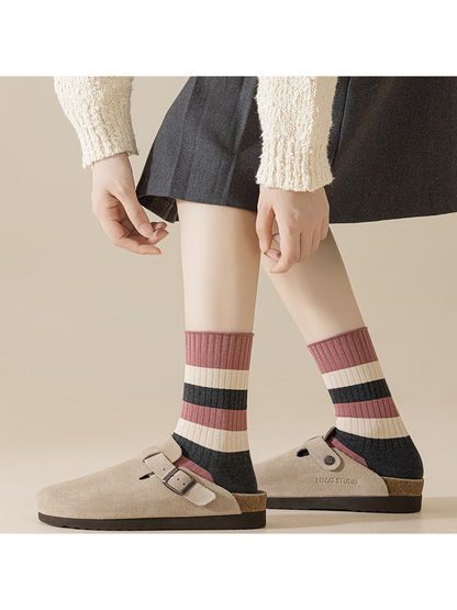 Wide-striped dusty-pink, ivory and dark gray crew socks worn with clogs