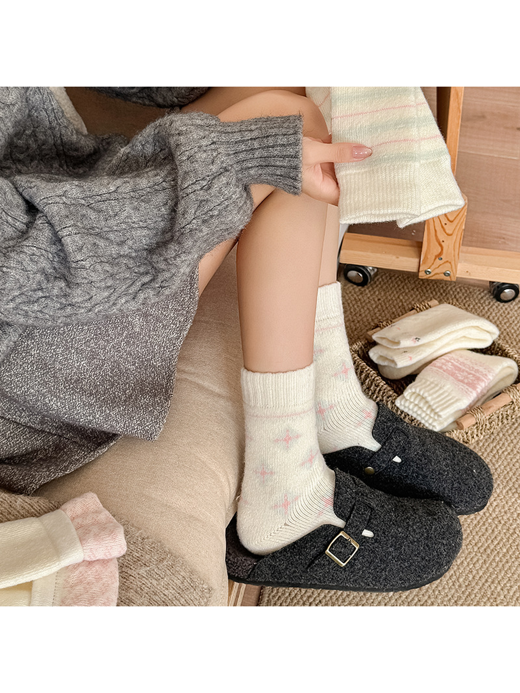 Cross-star crew socks styled with dark clogs while a striped style is held nearby