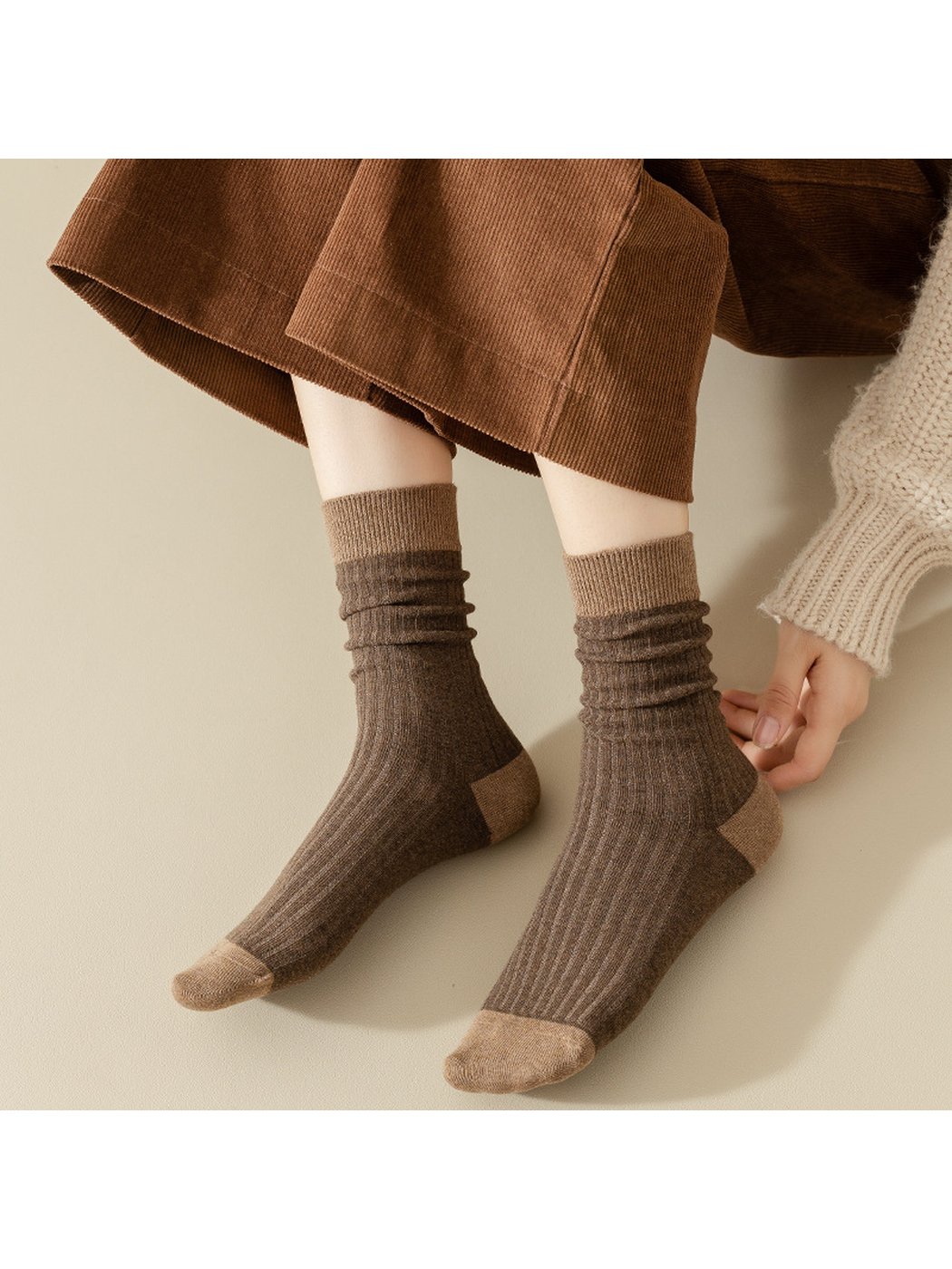 Brown ribbed crew socks with contrasting cuffs styled in a relaxed drape