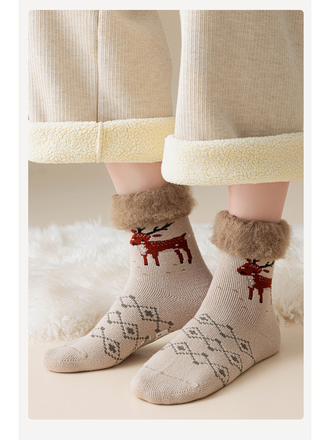 Beige reindeer crew socks worn with fuzzy cuffs folded down