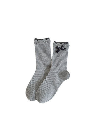 Gray ribbed crew socks with scalloped cuffs and a polka-dot bow