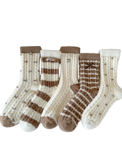 Five ivory and brown fuzzy crew sock styles arranged together