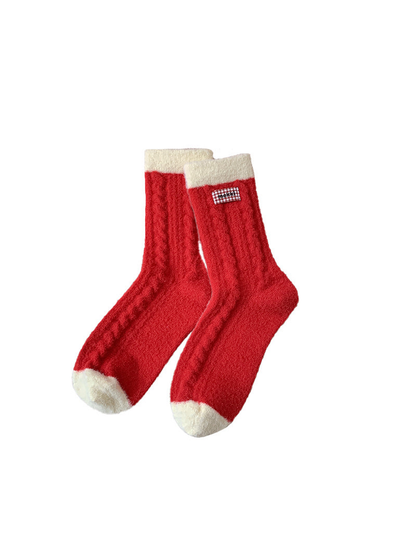 Red fuzzy crew socks with ivory cuffs and gingham label
