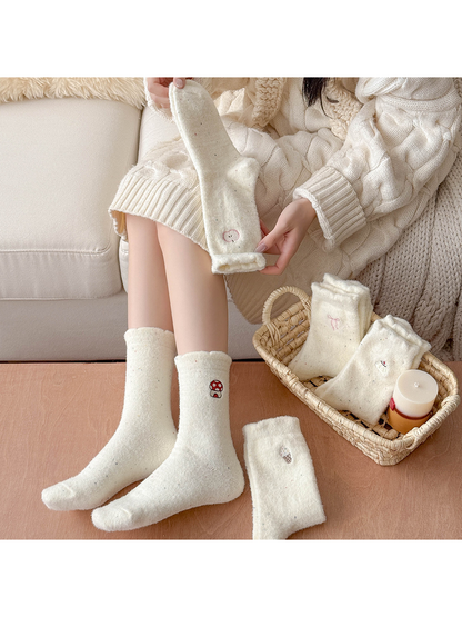 Ivory fuzzy embroidered crew socks styled with a cream knit outfit