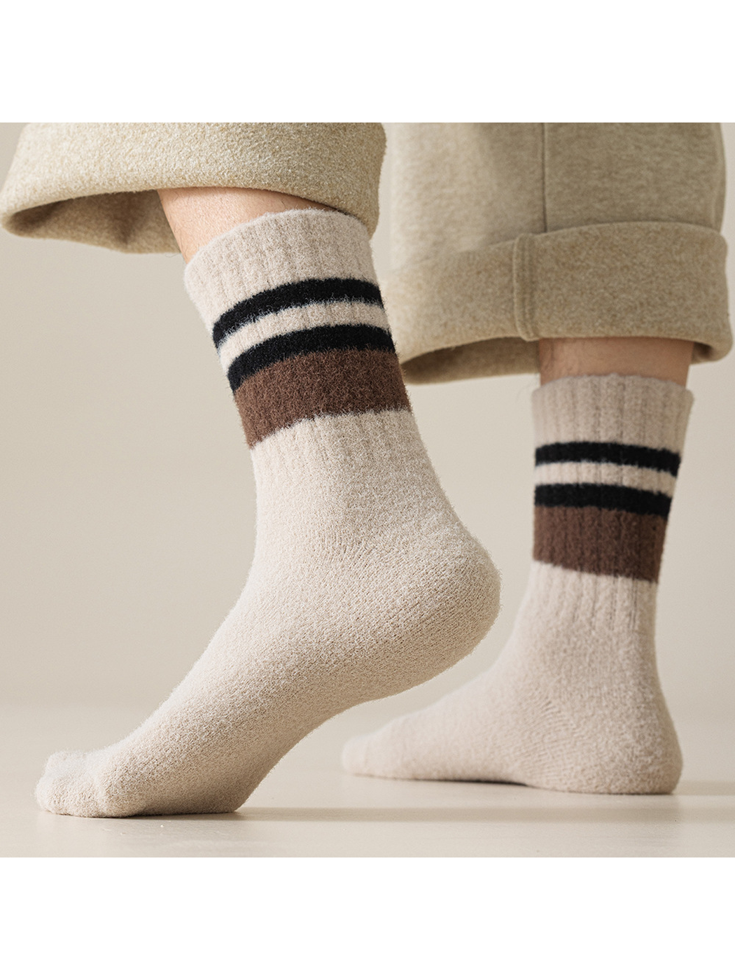 Light beige striped crew socks worn with cuffed trousers