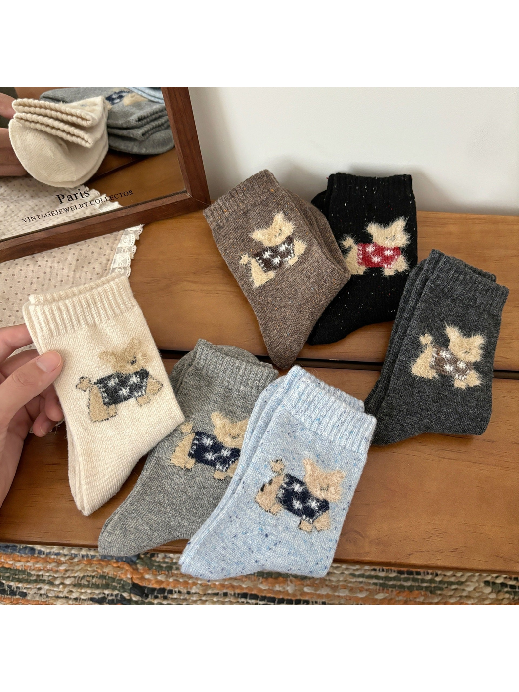 Six colors of crew socks with fuzzy cat motifs displayed together