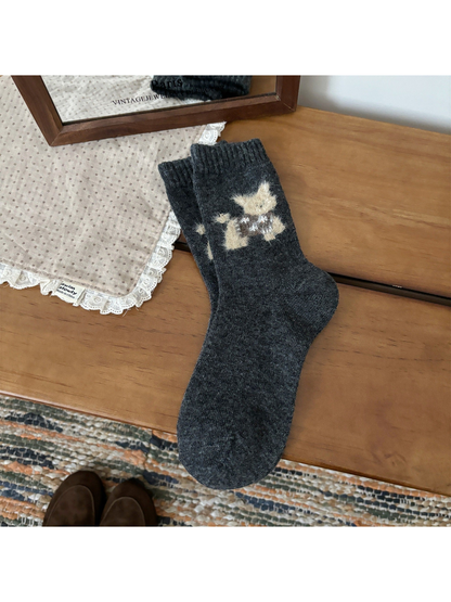 Dark gray crew socks with a fuzzy cat motif and ribbed cuffs