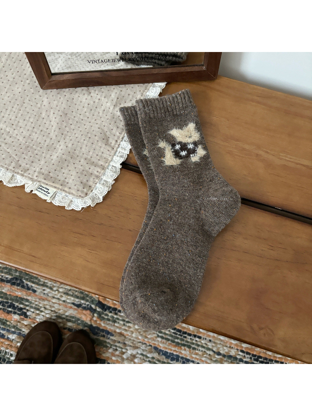 Brown crew socks with a fuzzy cat motif and ribbed cuffs