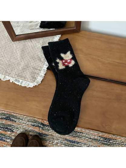 Black crew socks with a red fuzzy cat motif and ribbed cuffs