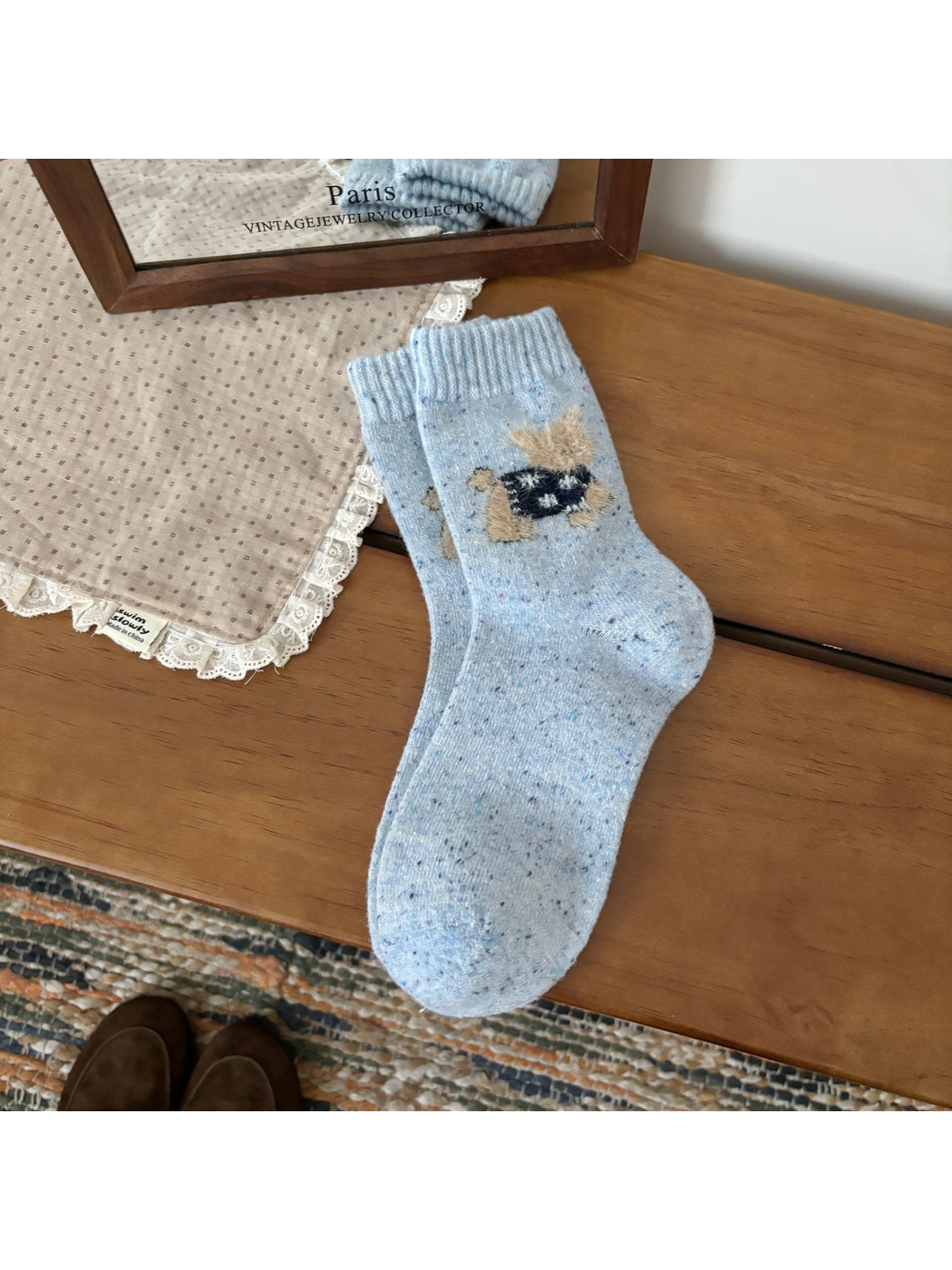 Light blue crew socks with a fuzzy cat motif and ribbed cuffs