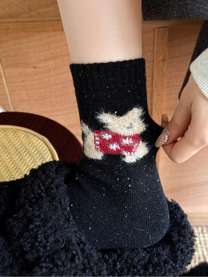 Close-up of the red fuzzy cat motif on a black crew sock