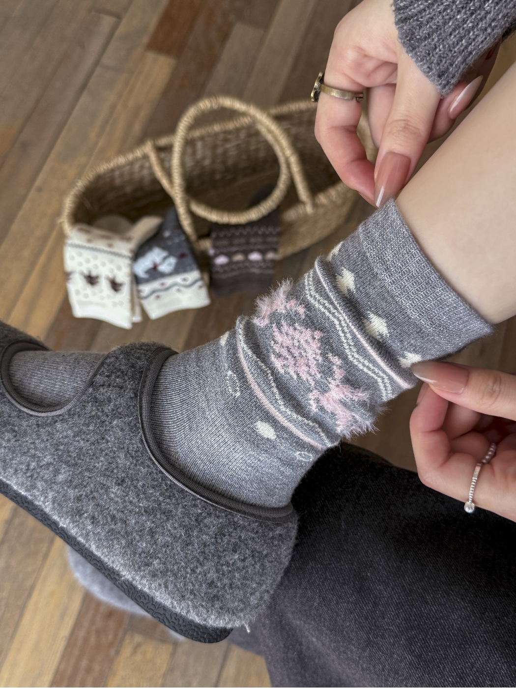 Close-up of the light gray sock cuff and fuzzy pink deer motif